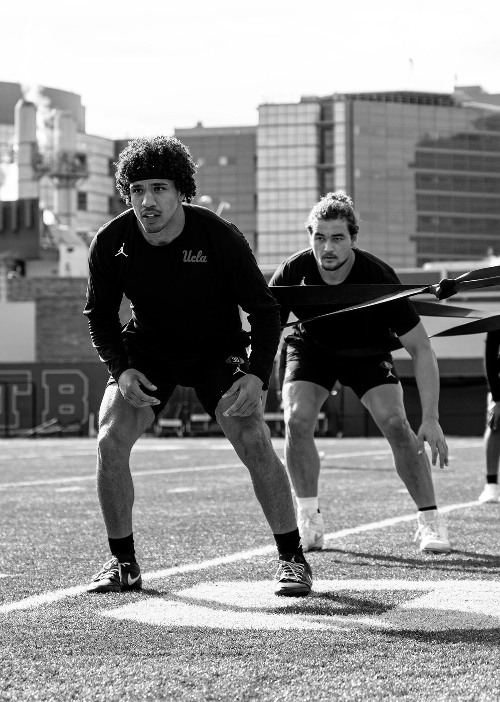 Minaya Olivo in an athletic ready position during a resistance-band start drill at UCLA